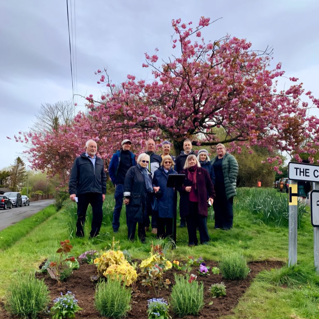 Memorial Garden..bench will sit where the people are standing